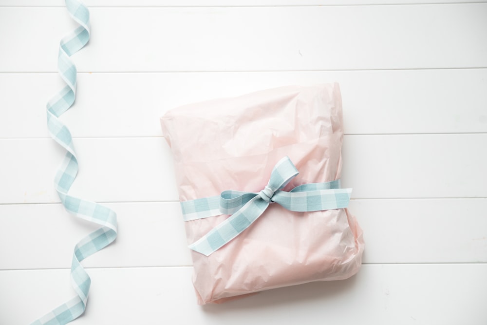 a present wrapped in pink and blue ribbon