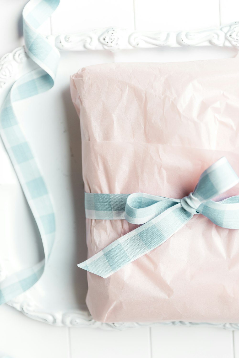 a wrapped present sitting on top of a white plate