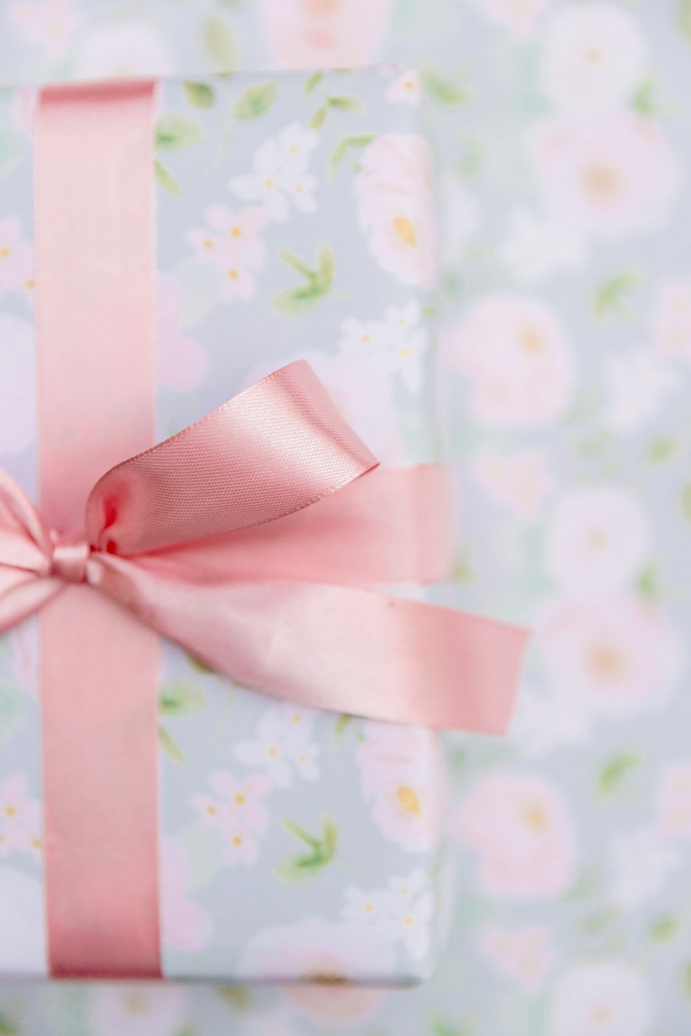 a present wrapped in pink ribbon with a pink bow