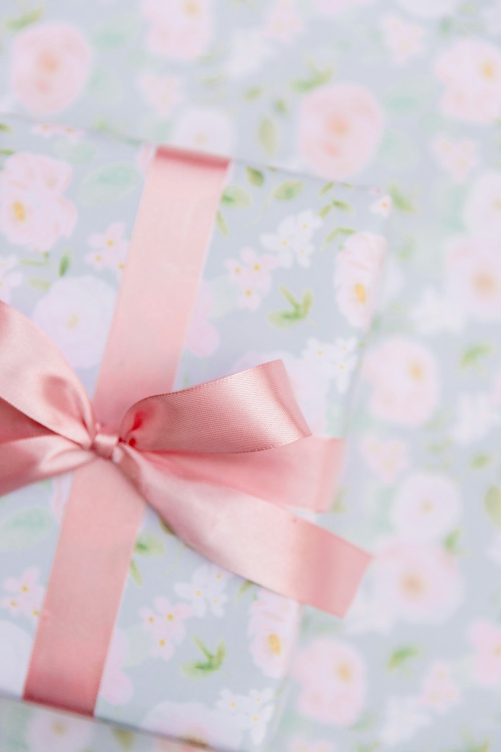 a present wrapped in pink ribbon with a pink bow
