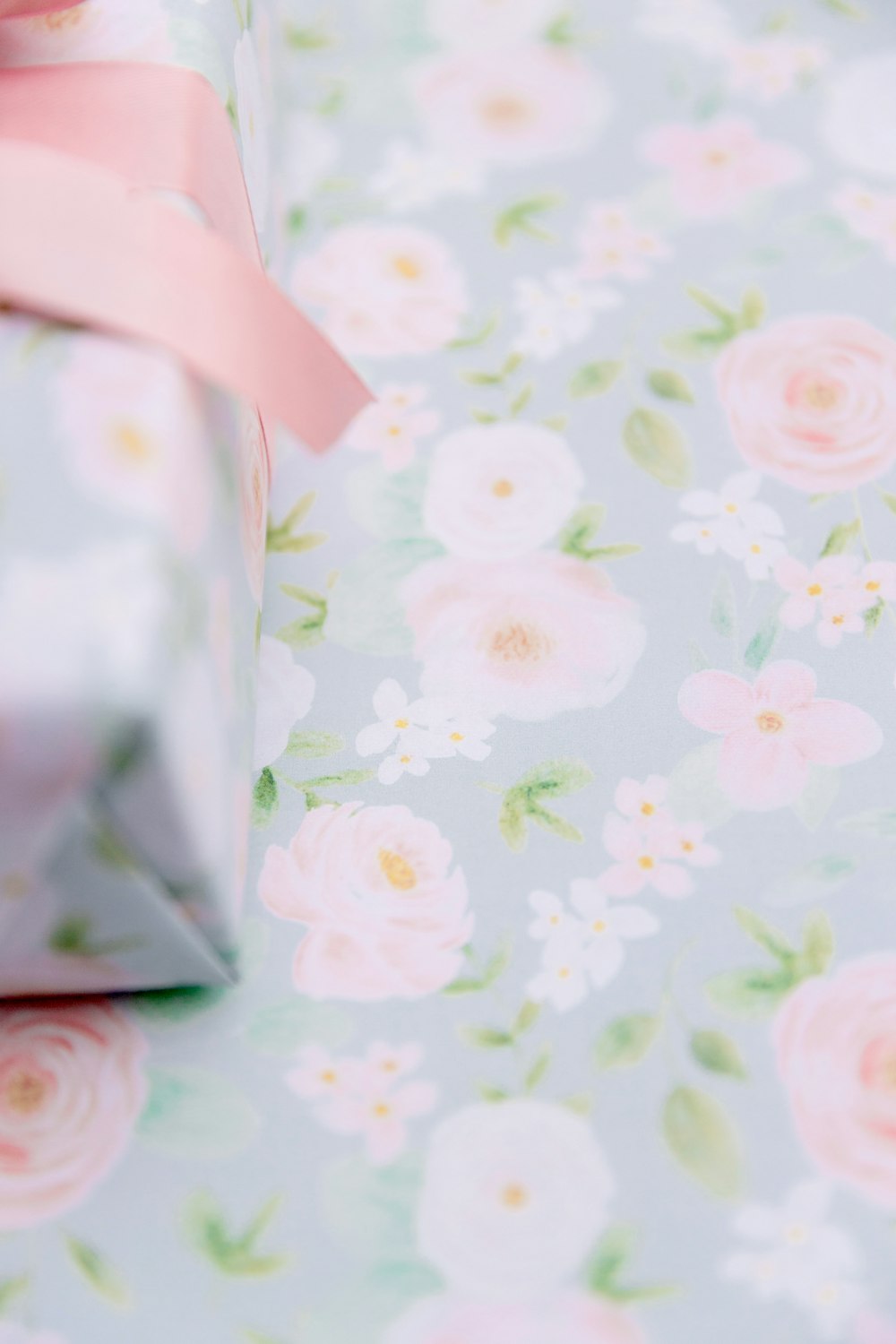 a wrapped gift box with a pink ribbon