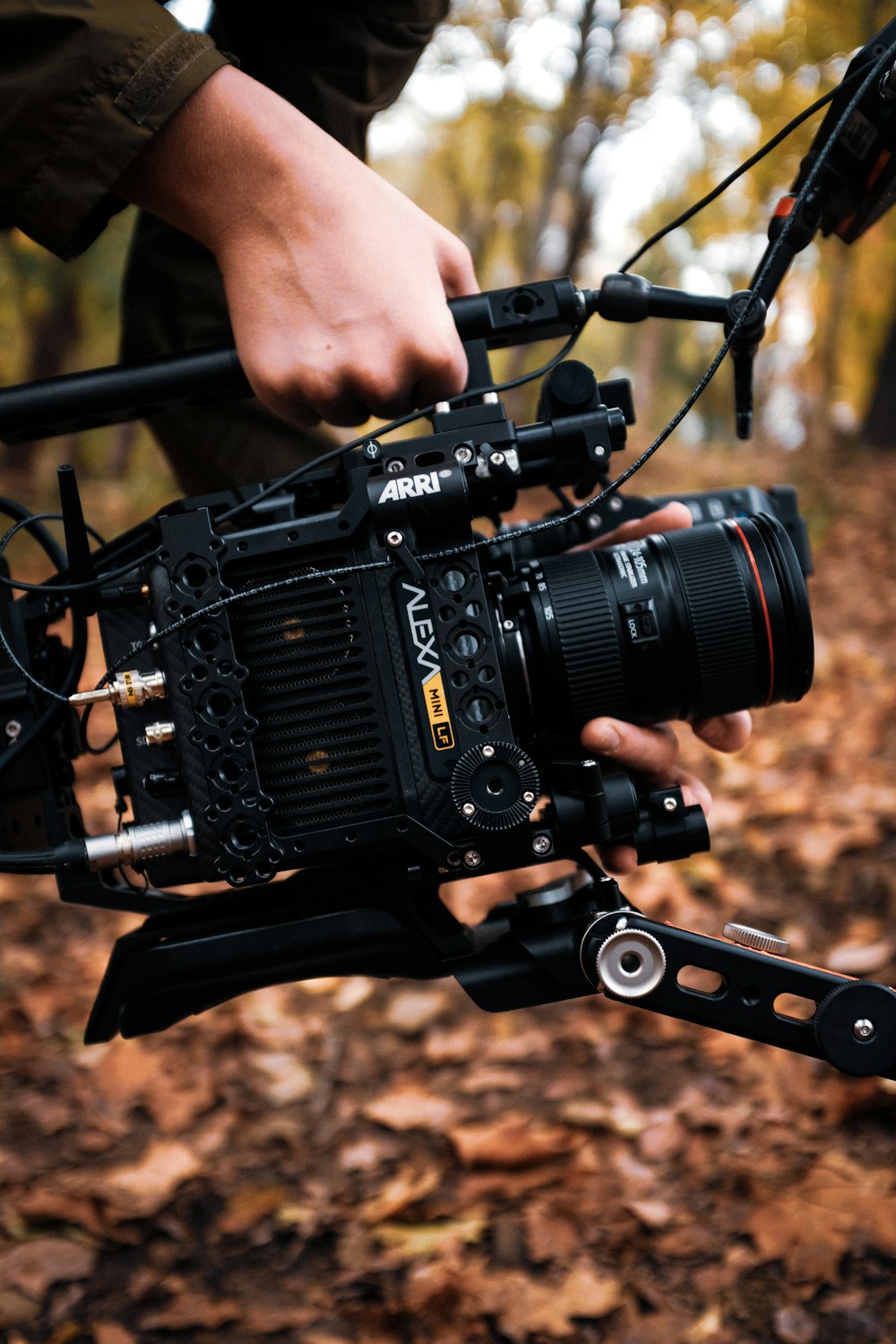 a person holding a camera on a tripod