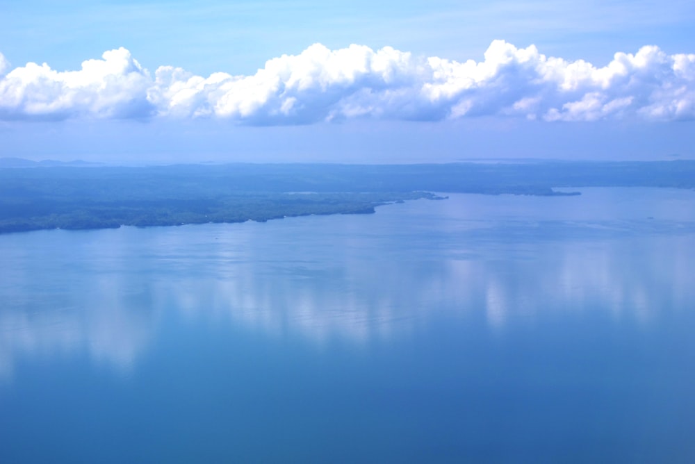 a large body of water surrounded by clouds