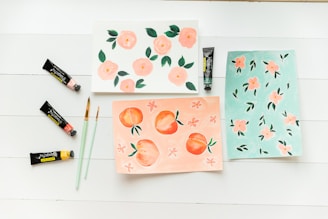 a white table topped with cards and paint