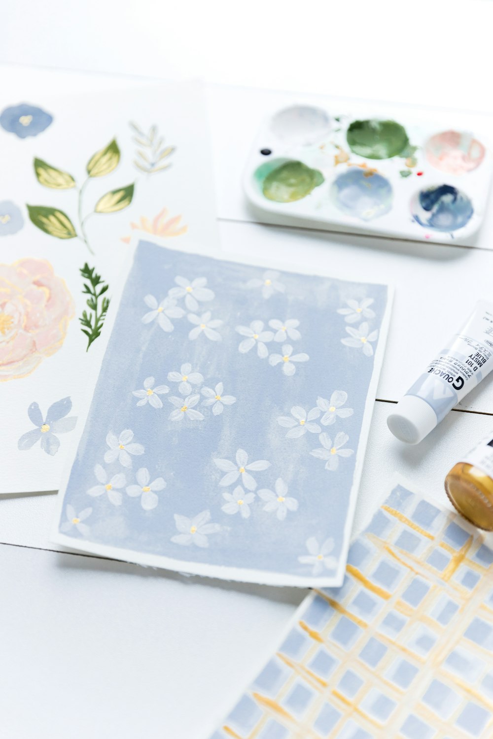 a white table topped with lots of art supplies