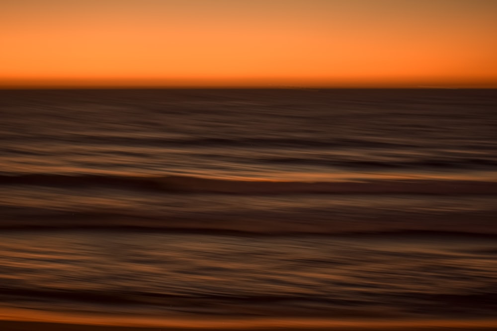 a blurry photo of the ocean at sunset