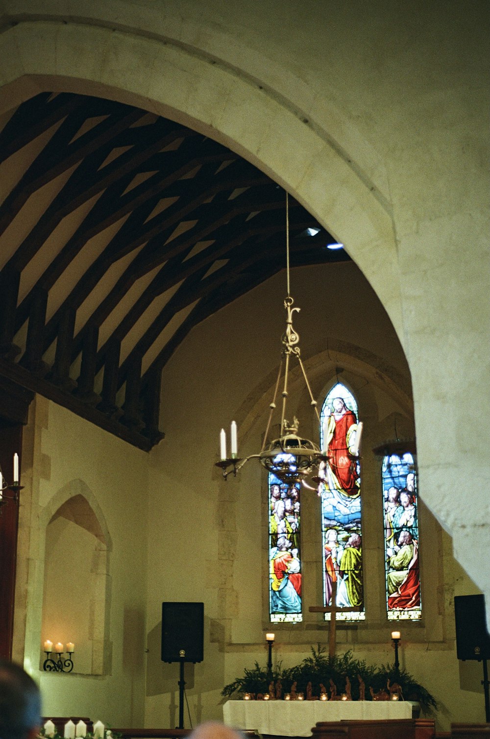 a church with a chandelier and stained glass windows