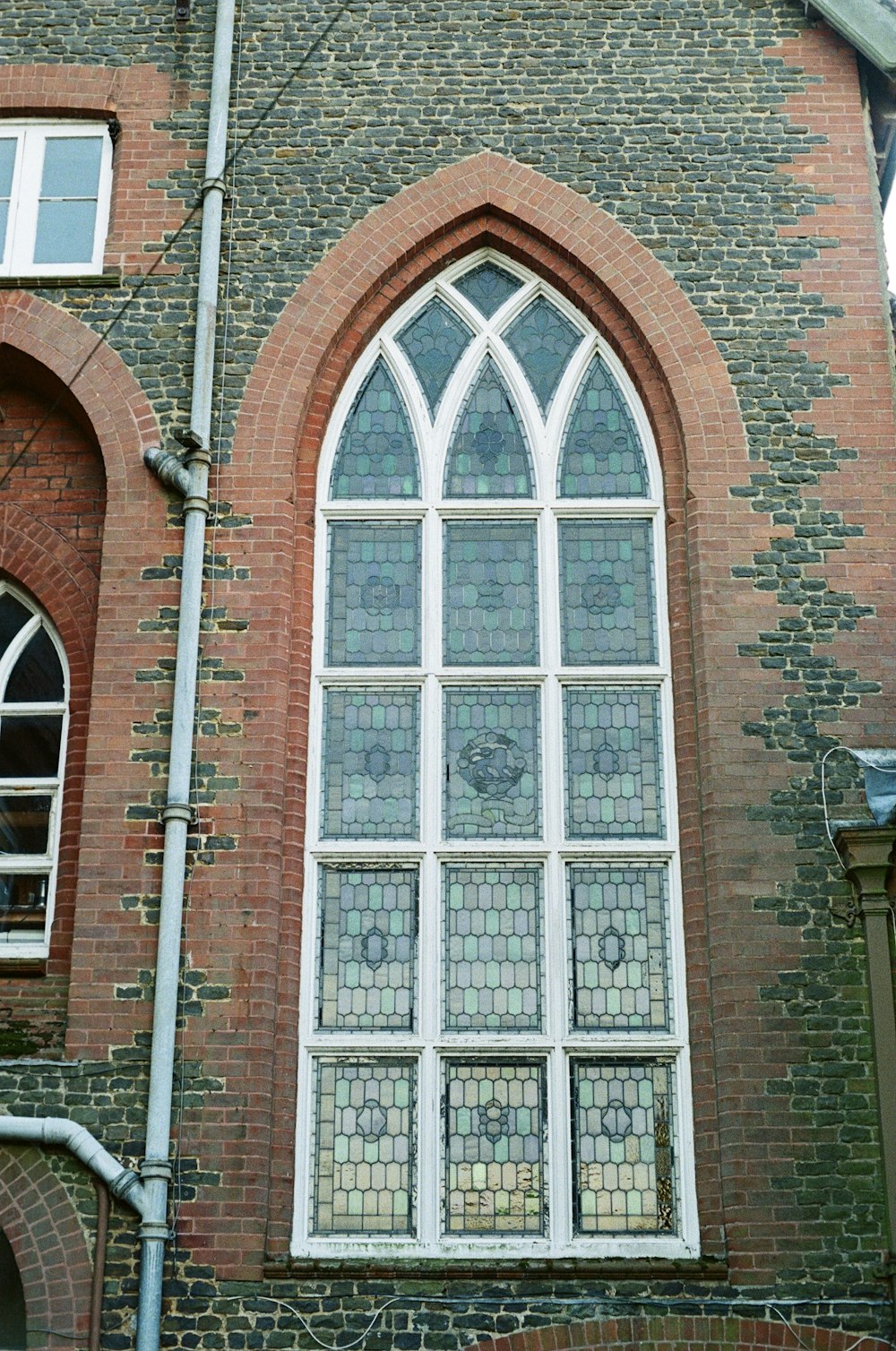 a tall brick building with a large window