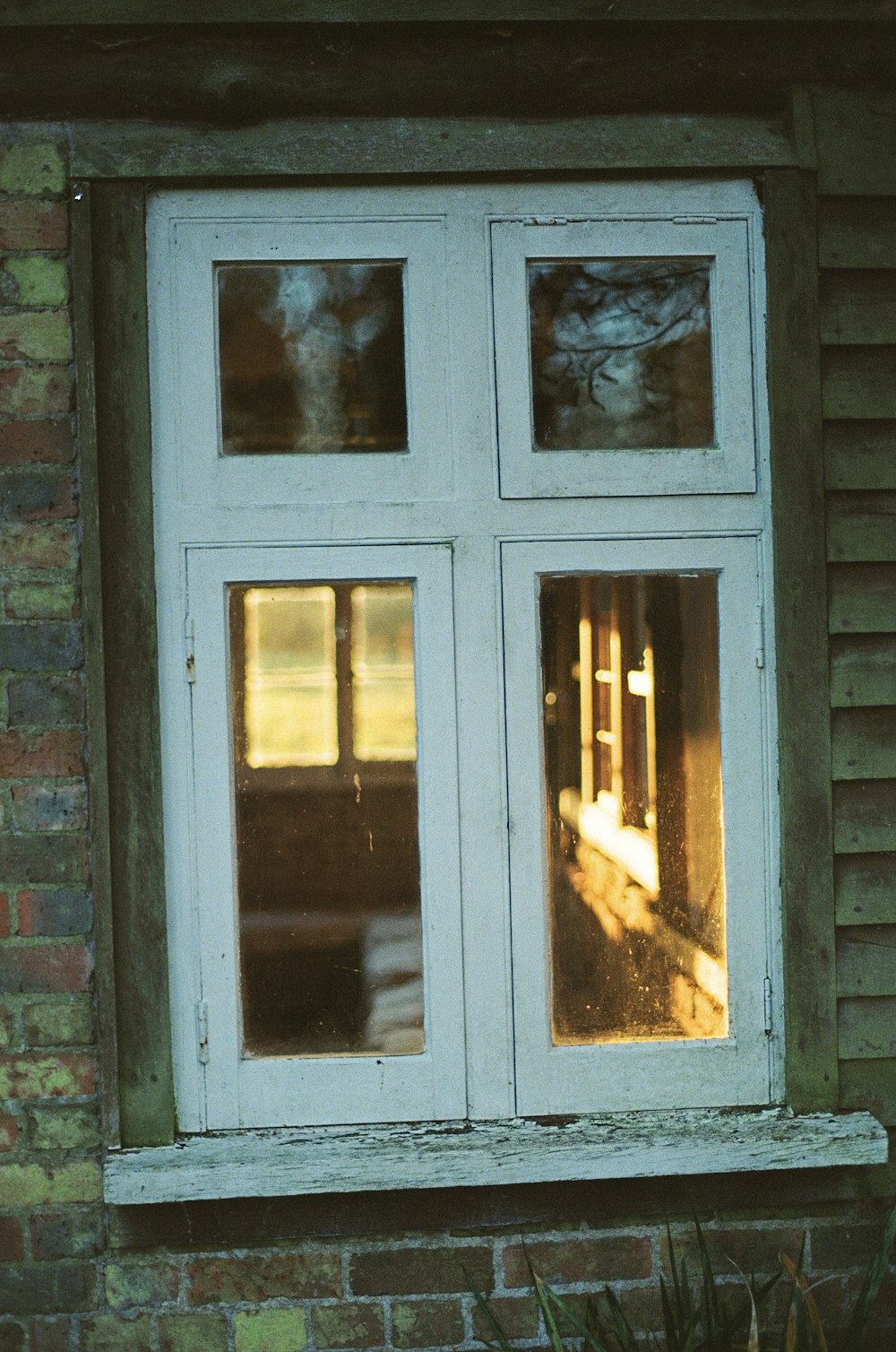 a cat sitting in the window of a house