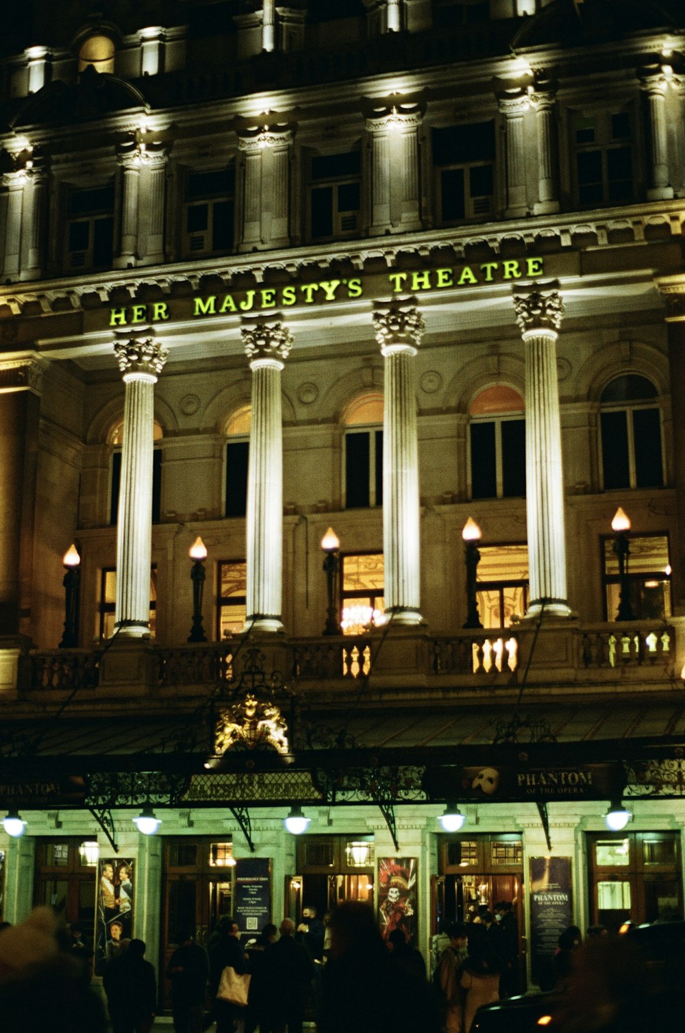 a large building with columns lit up at night