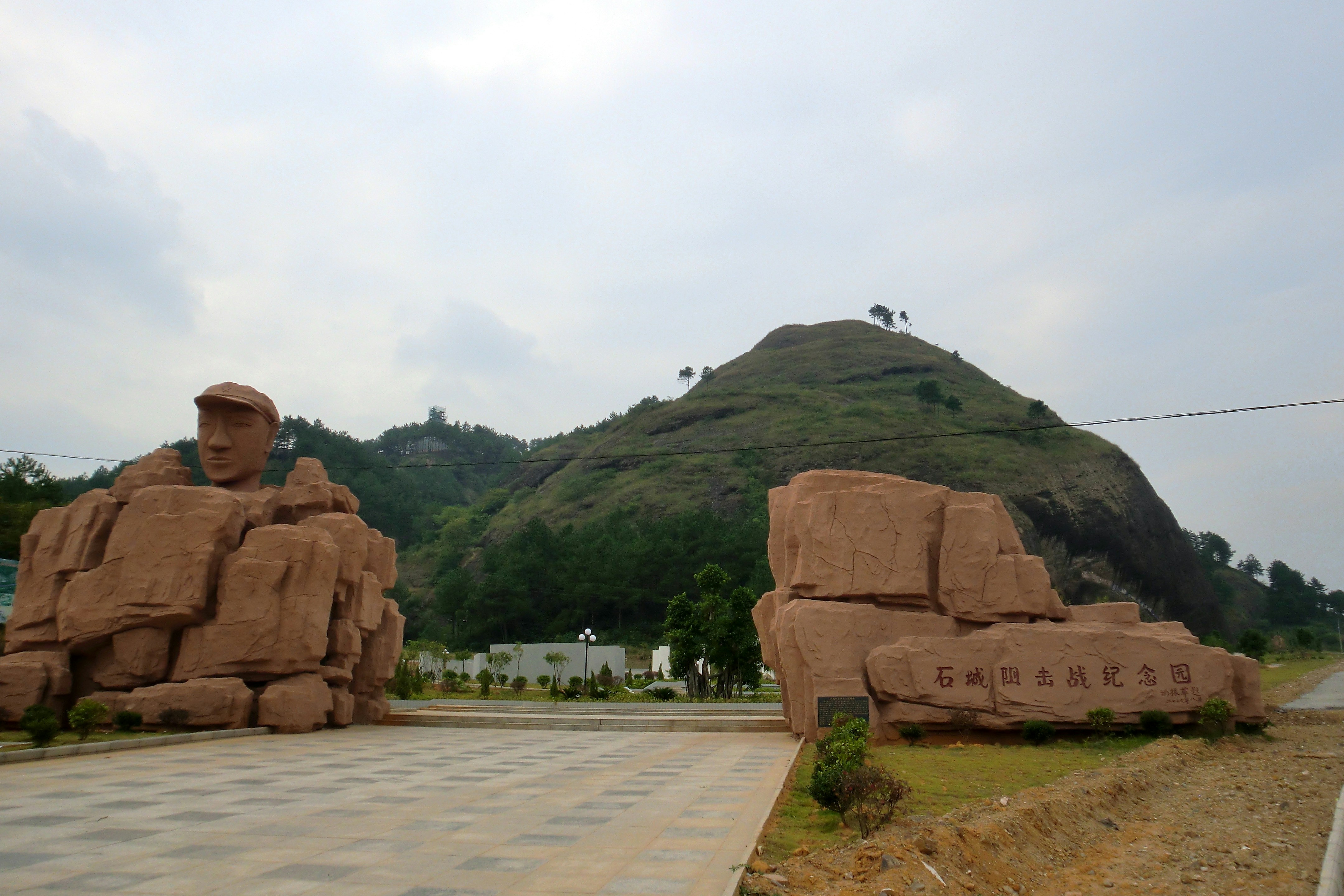 a large rock formation in front of a mountain