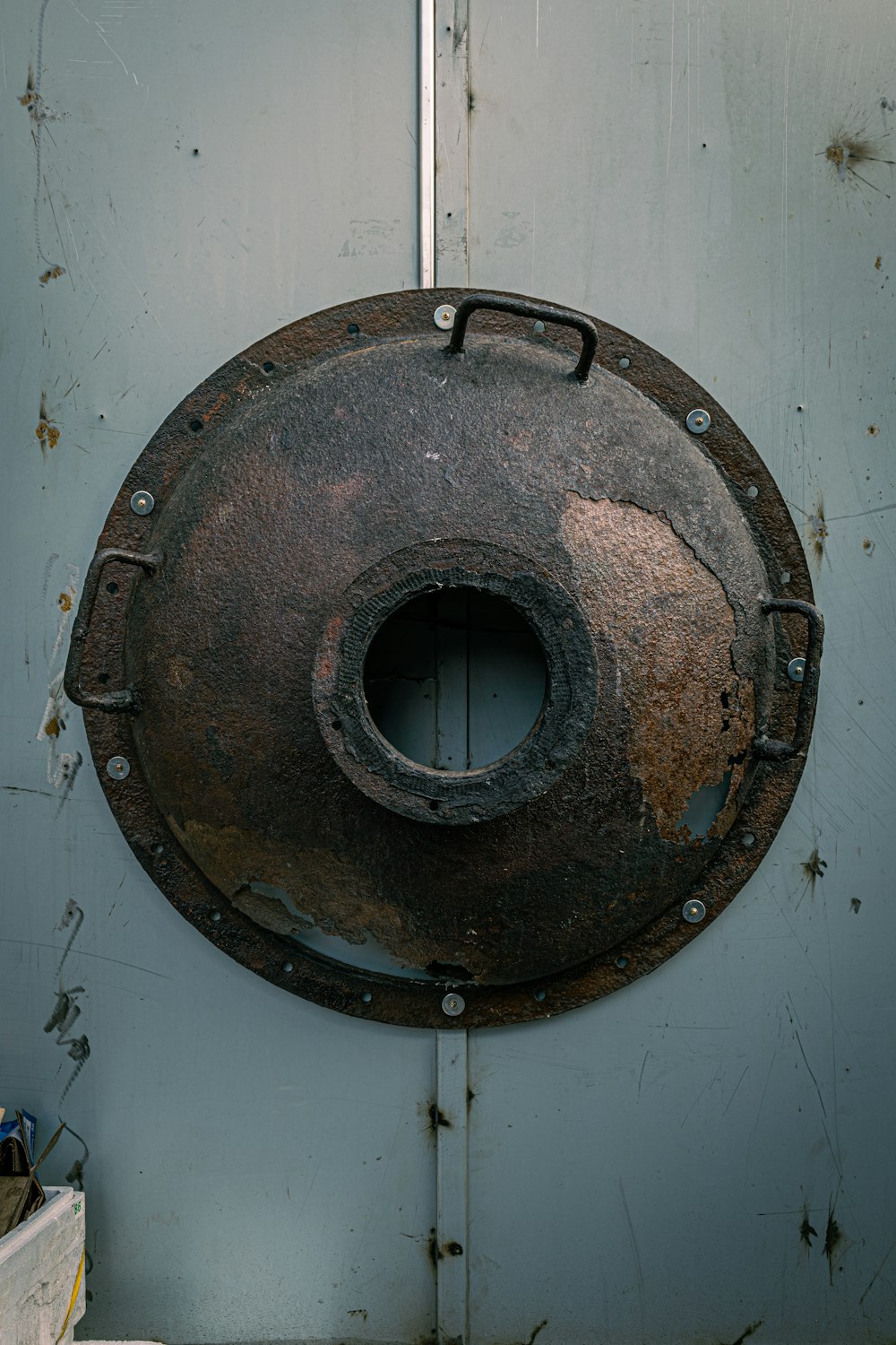 a rusted metal object hanging on a door