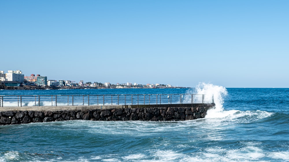 a man riding a surfboard on top of a wave in the ocean