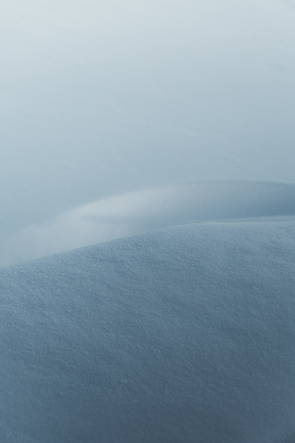 a snow covered hill with a sky background