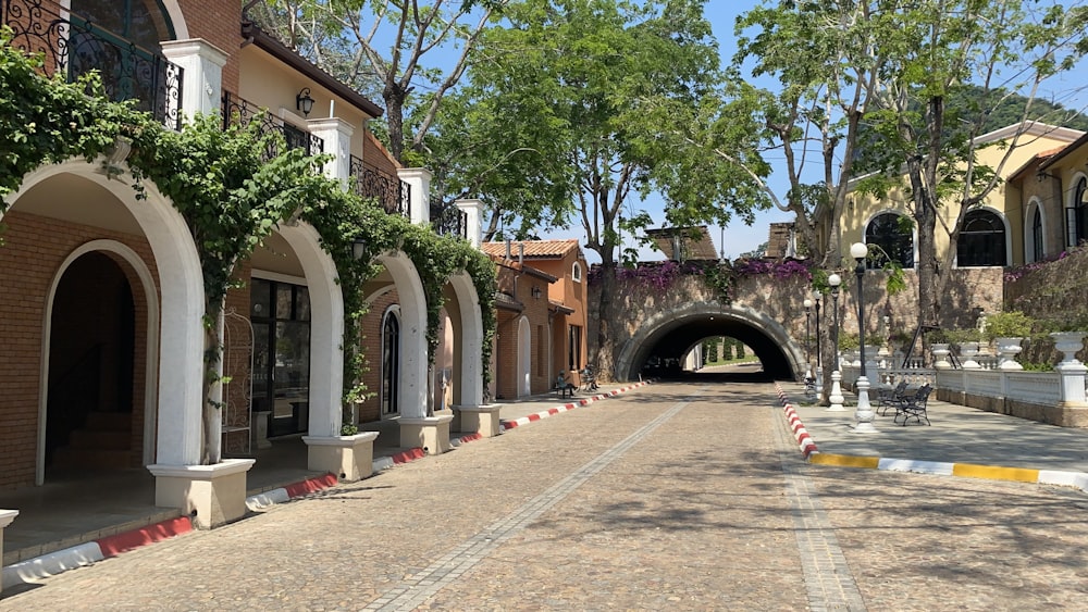 a street with a tunnel between two buildings