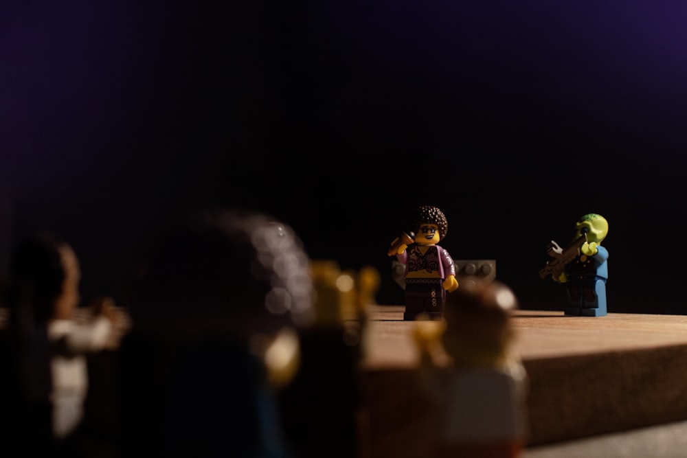 a group of lego figures sitting on top of a stage