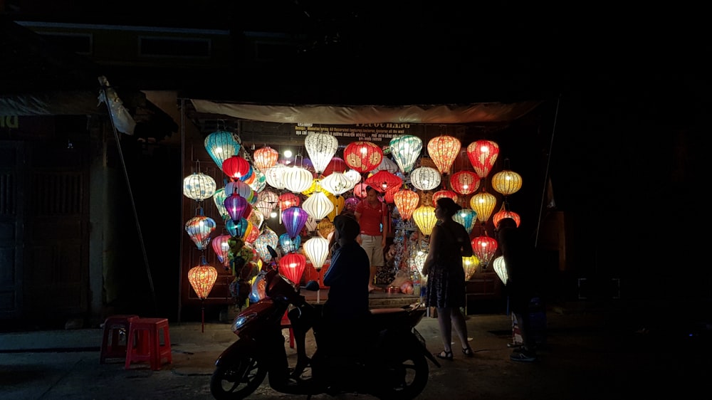 a motorcycle parked in front of a display of lanterns