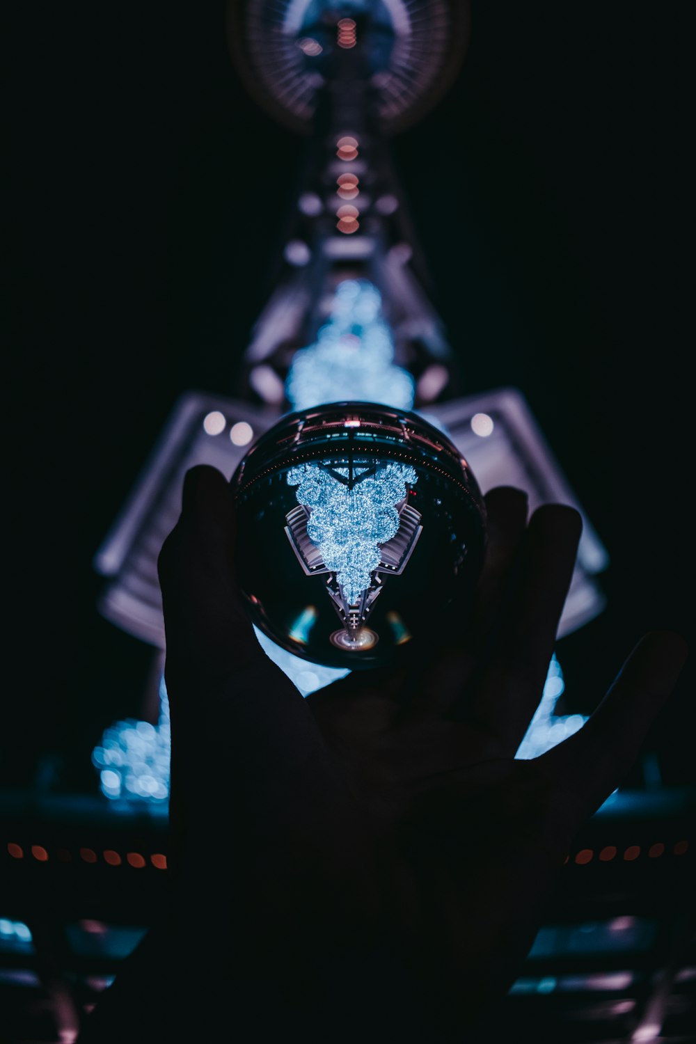 a person holding a glass ball in their hand