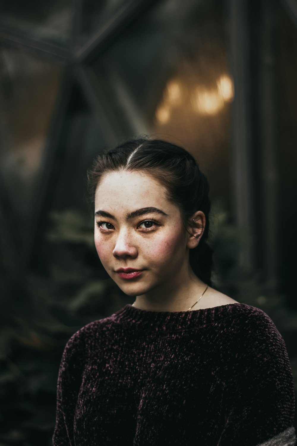 a woman in a black sweater looking at the camera