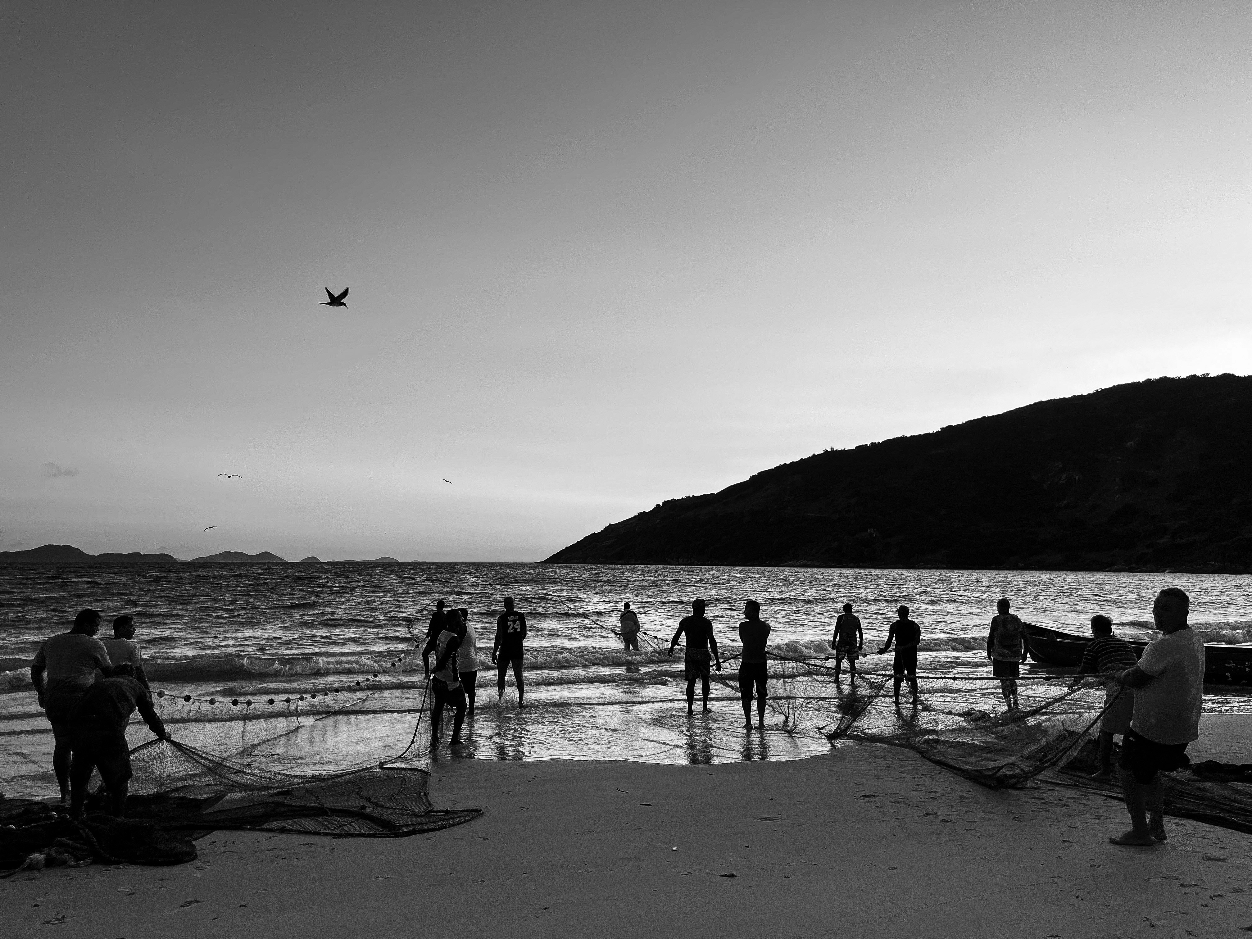 a group of people standing on top of a beach