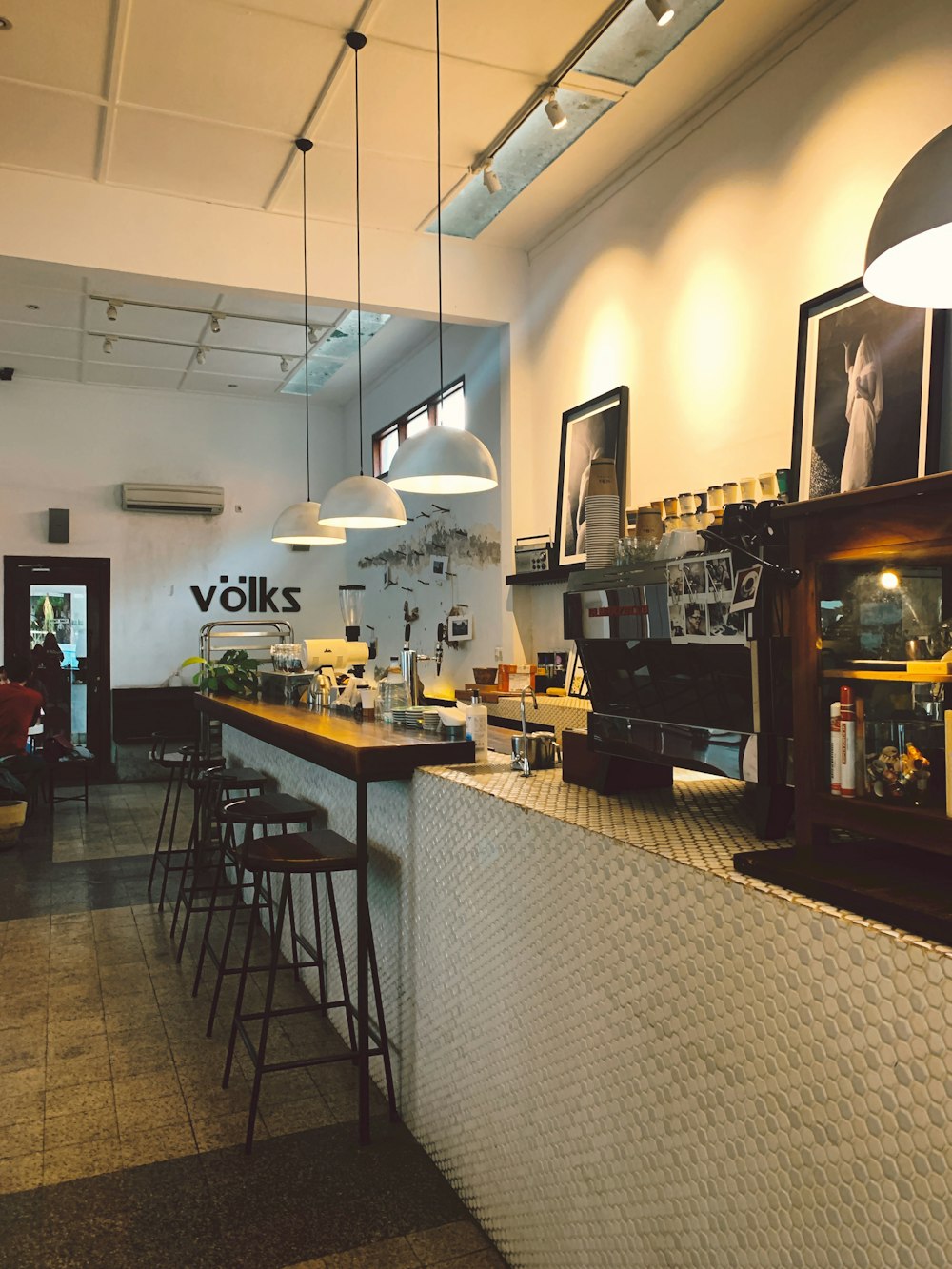 a bar with stools and a counter in a restaurant