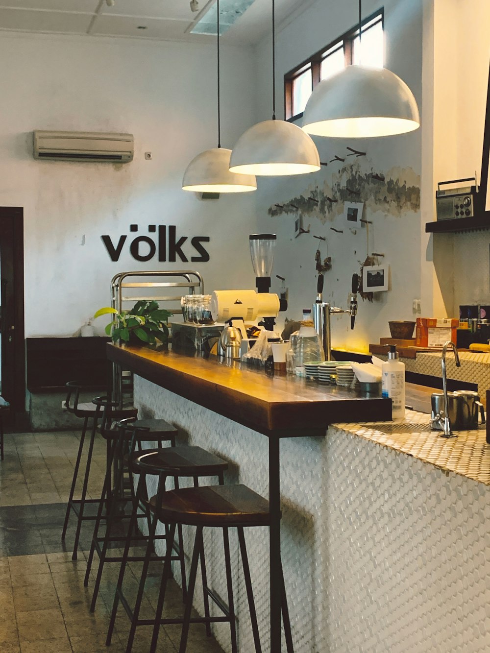 a restaurant with a long counter with stools