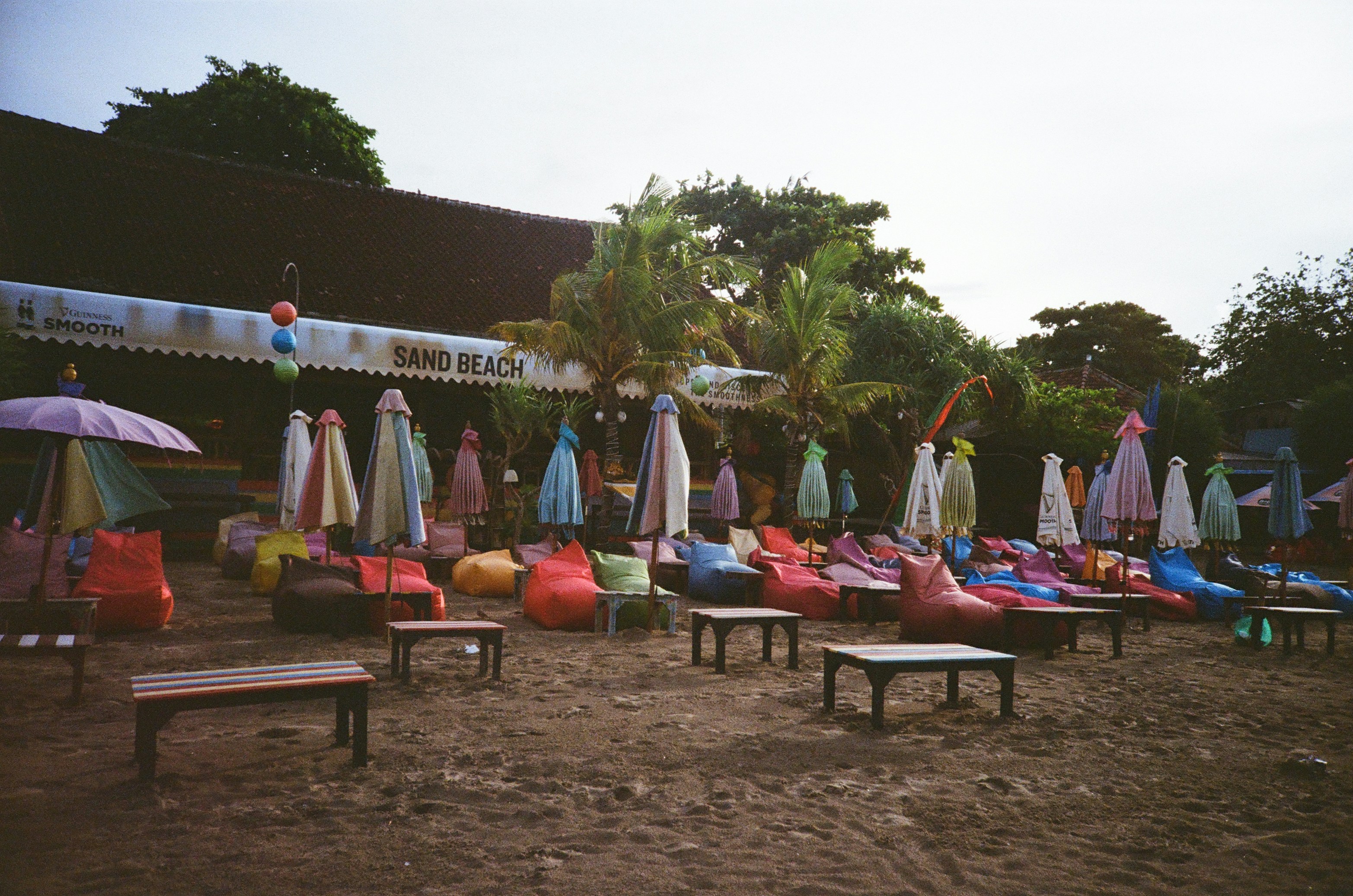 a bunch of beach chairs and umbrellas on the beach, 