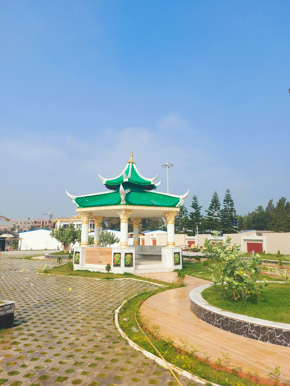 a white building with a green roof on a sunny day