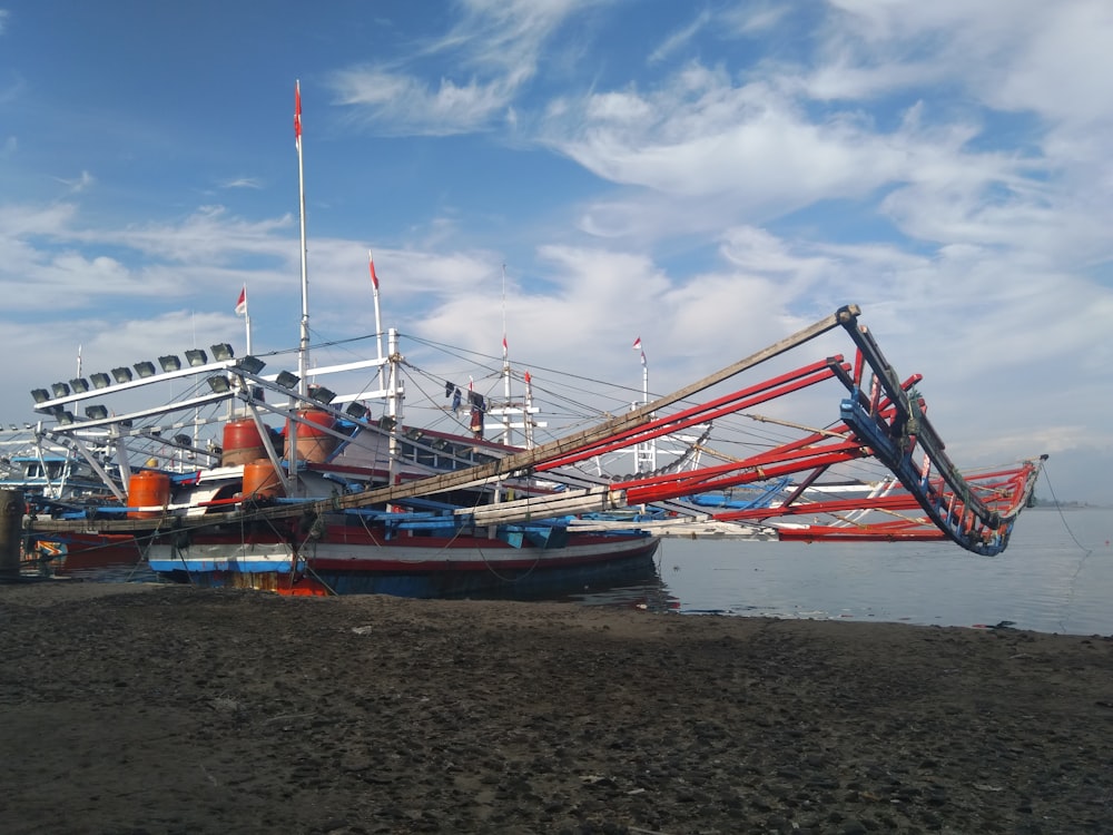 a large boat sitting on top of a sandy beach