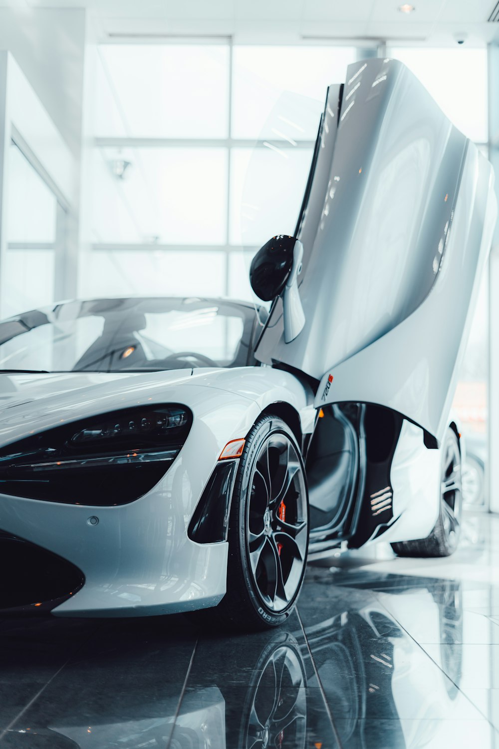 a white sports car parked inside of a building