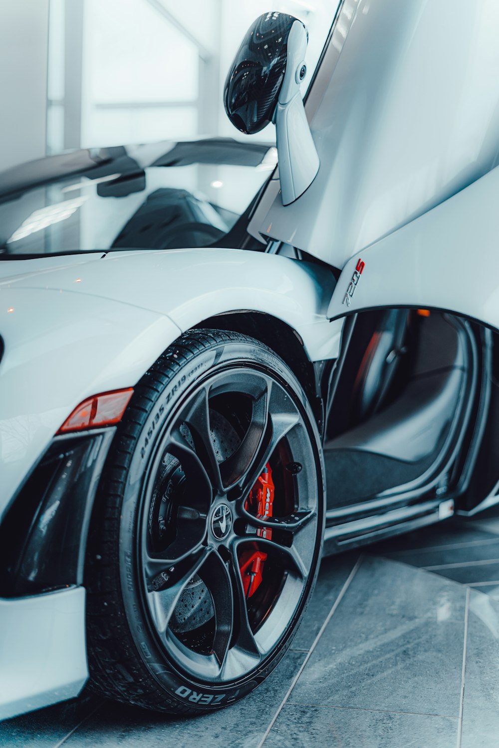 a white sports car parked in a garage