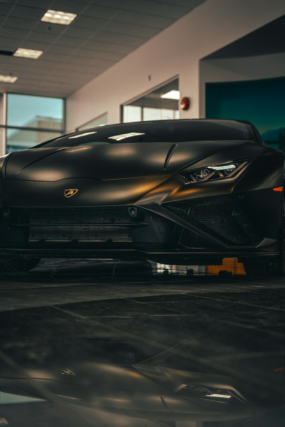 a black sports car parked inside of a building