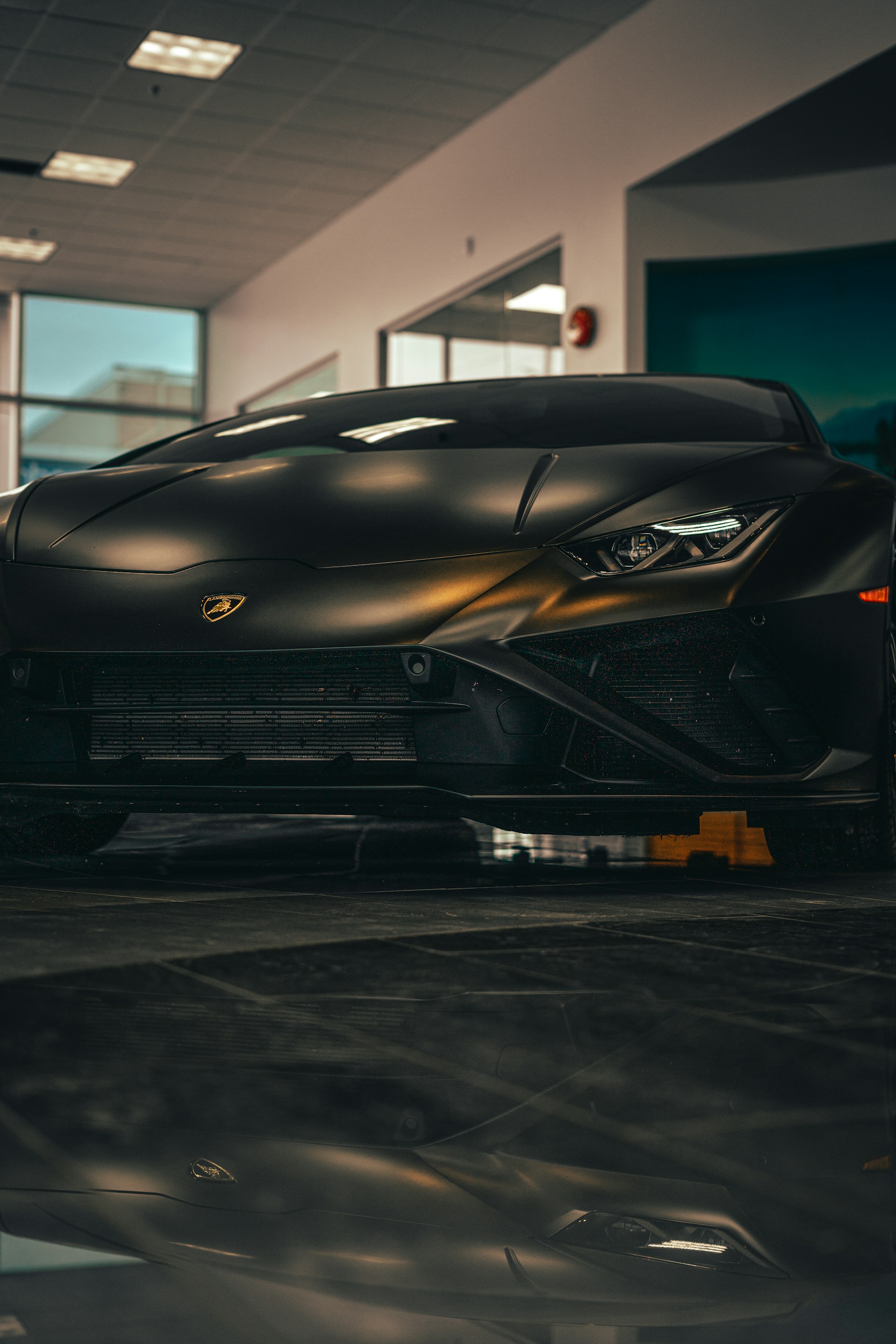 a black sports car parked inside of a building