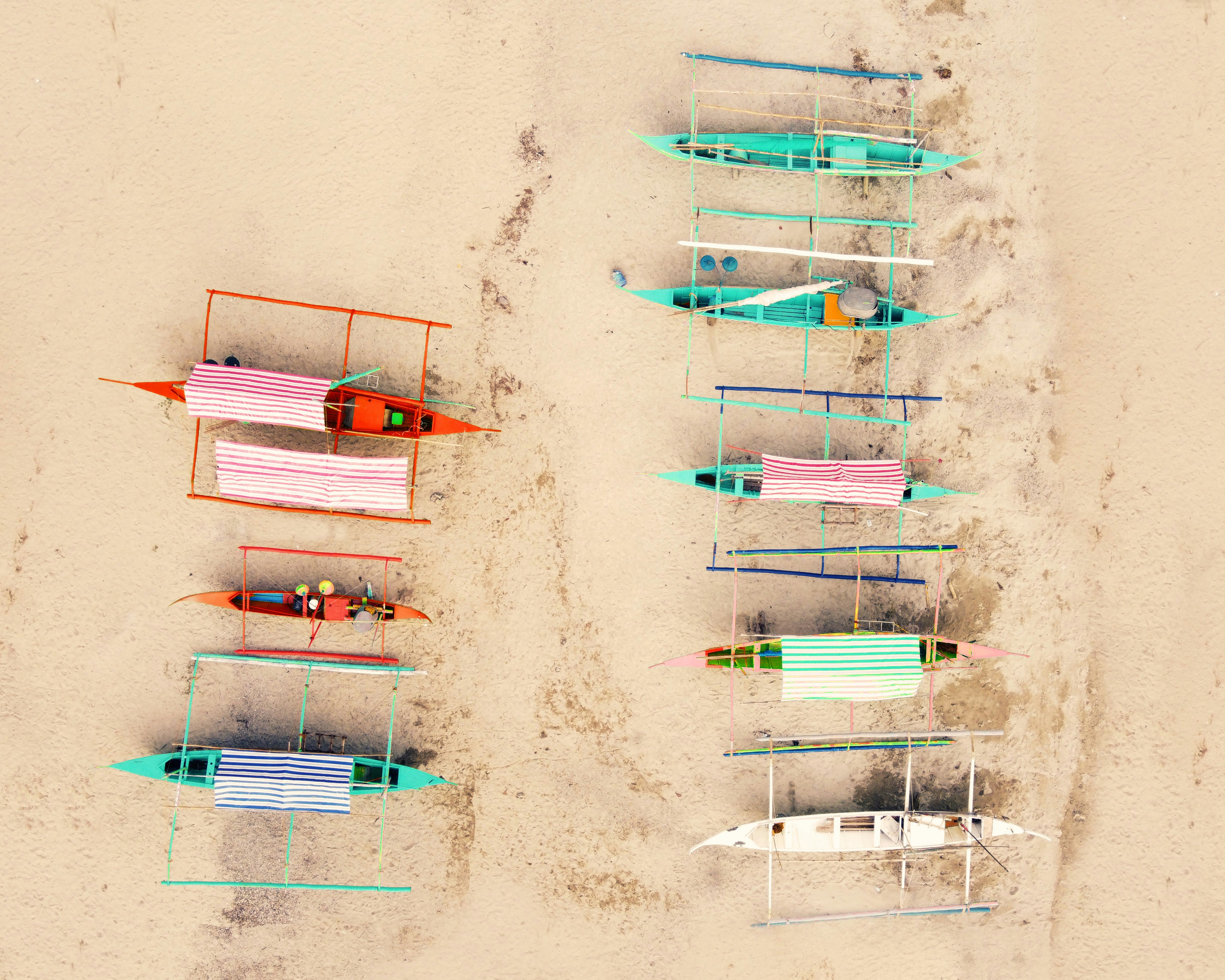 A row of beach chairs sitting on top of a sandy beach photo – Free Sea ...