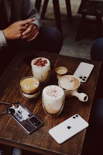 a couple of drinks sitting on top of a wooden table