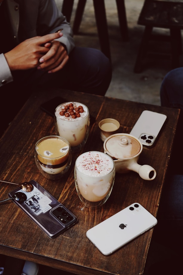 a couple of drinks sitting on top of a wooden table