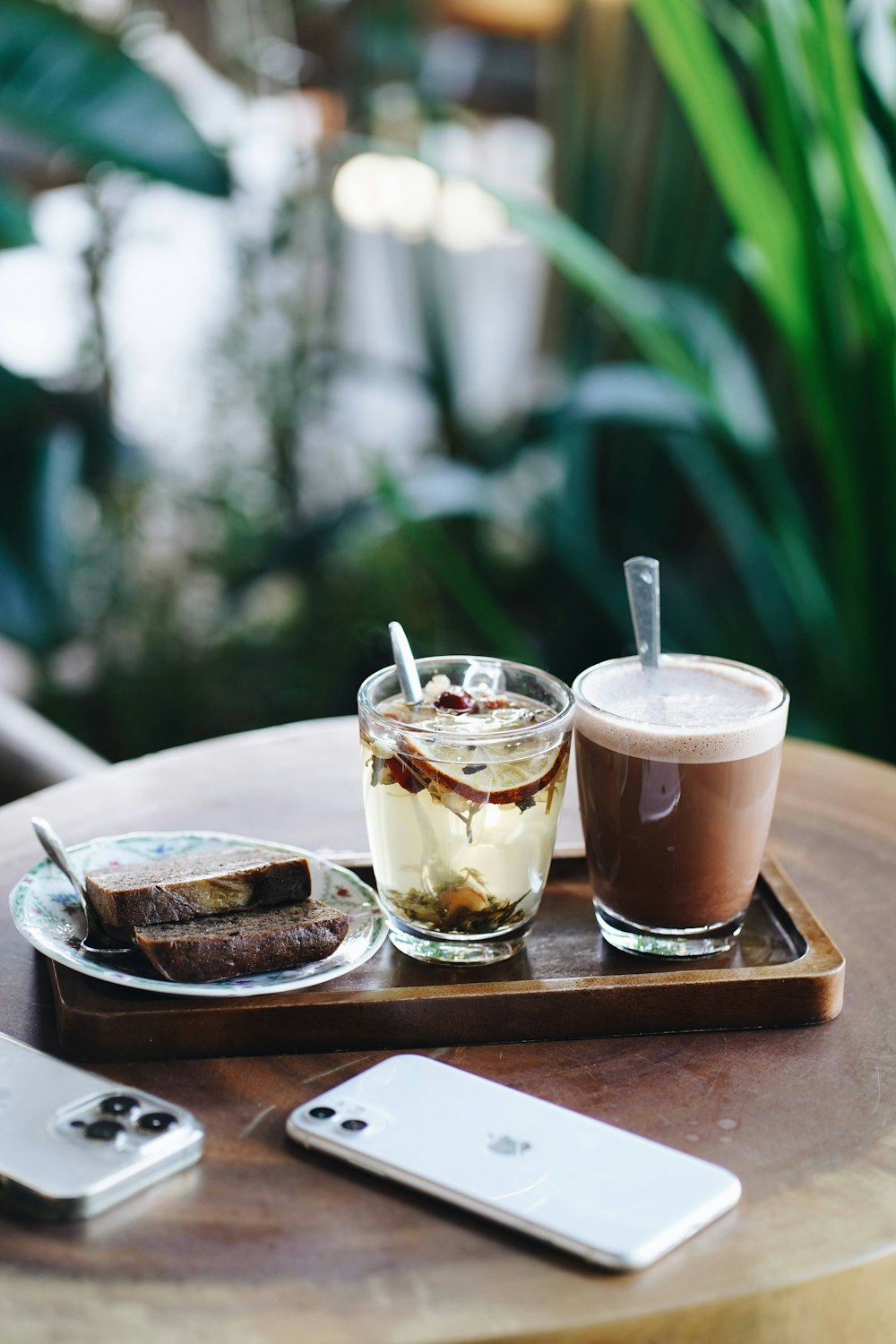 a tray with two drinks and a cell phone on it