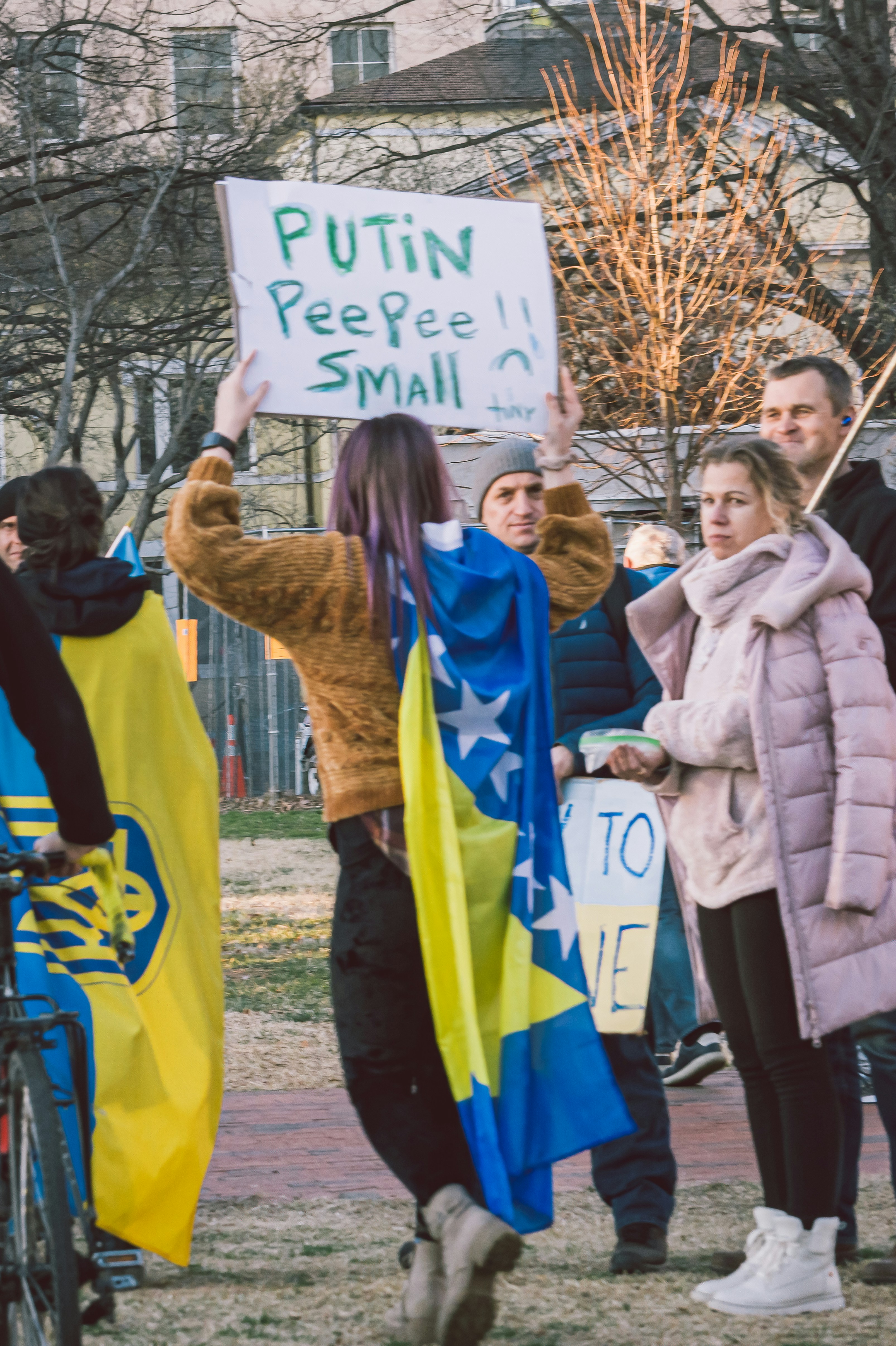 A group of people holding signs in a park photo – Free Peace Image on ...