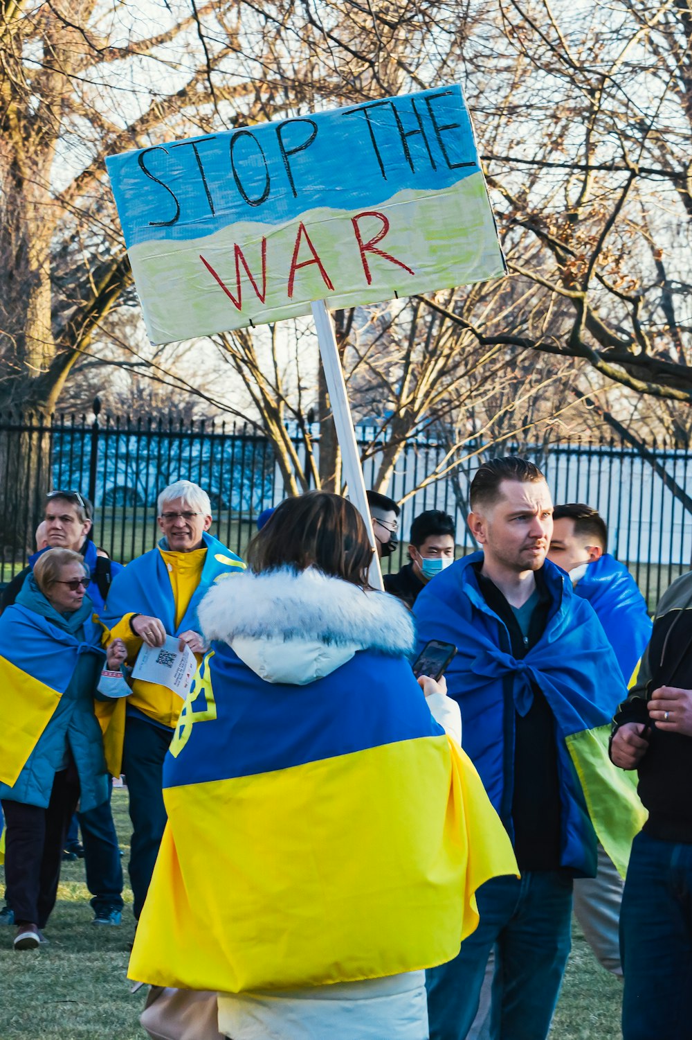 a group of people holding a sign that says stop the war