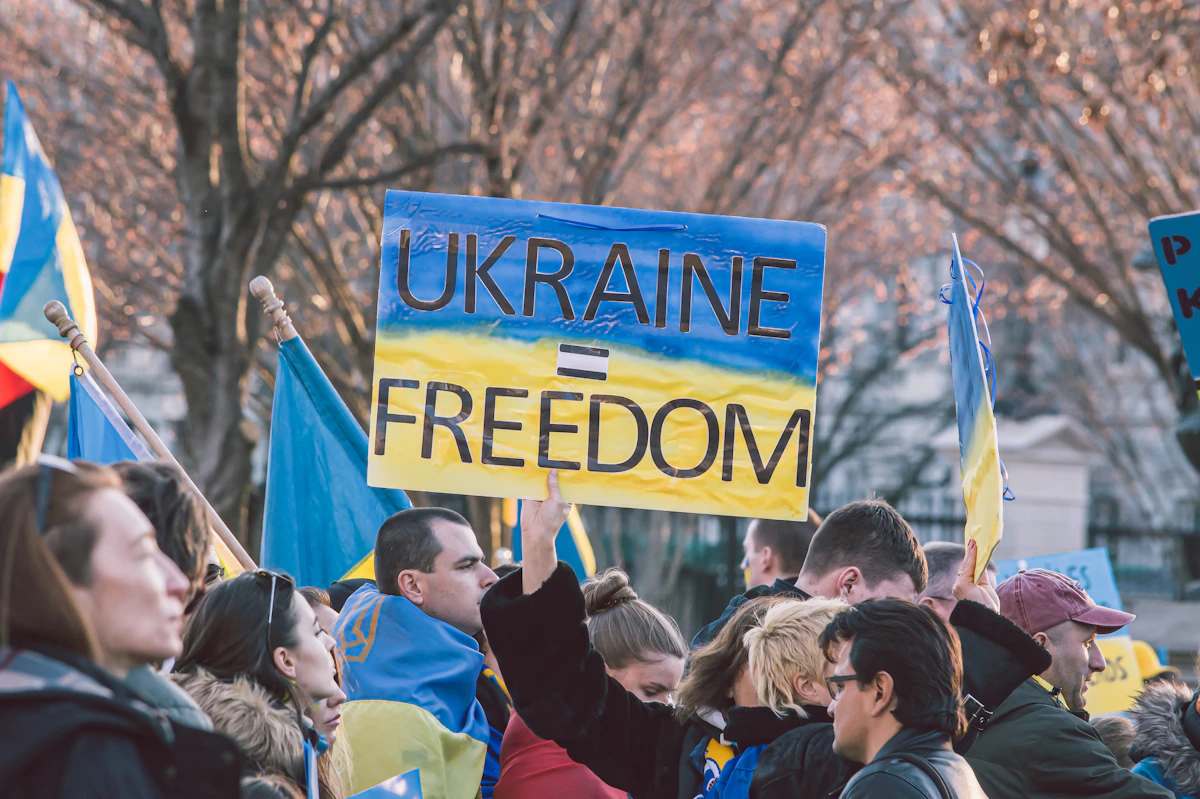 A crowd holding a sign reading Ukraine = Freedom