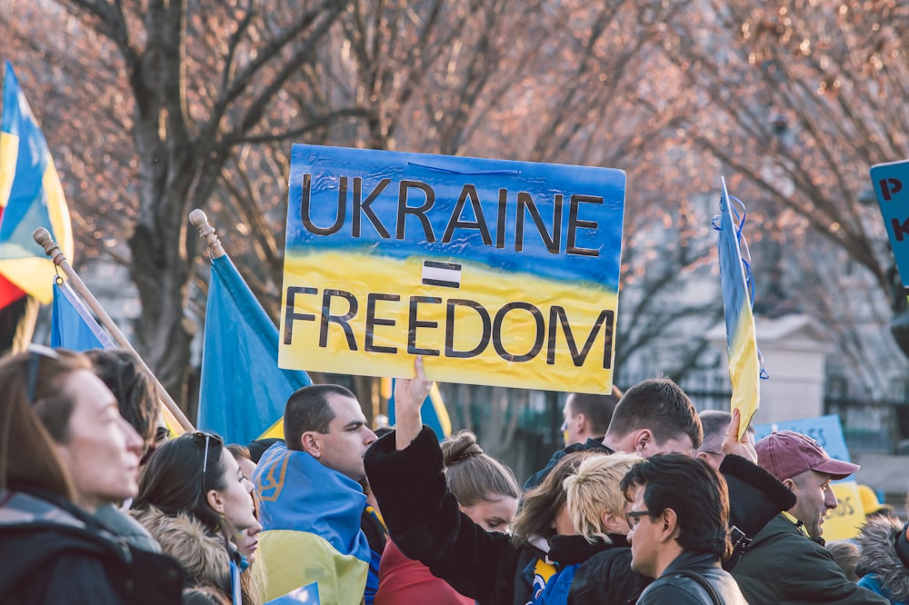 a large group of people holding up signs