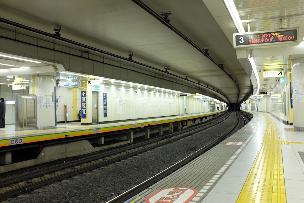 a subway station with a train on the tracks