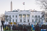 Close-up of the Liberty Bell with attendees in the background symbolizing democratic renewal.