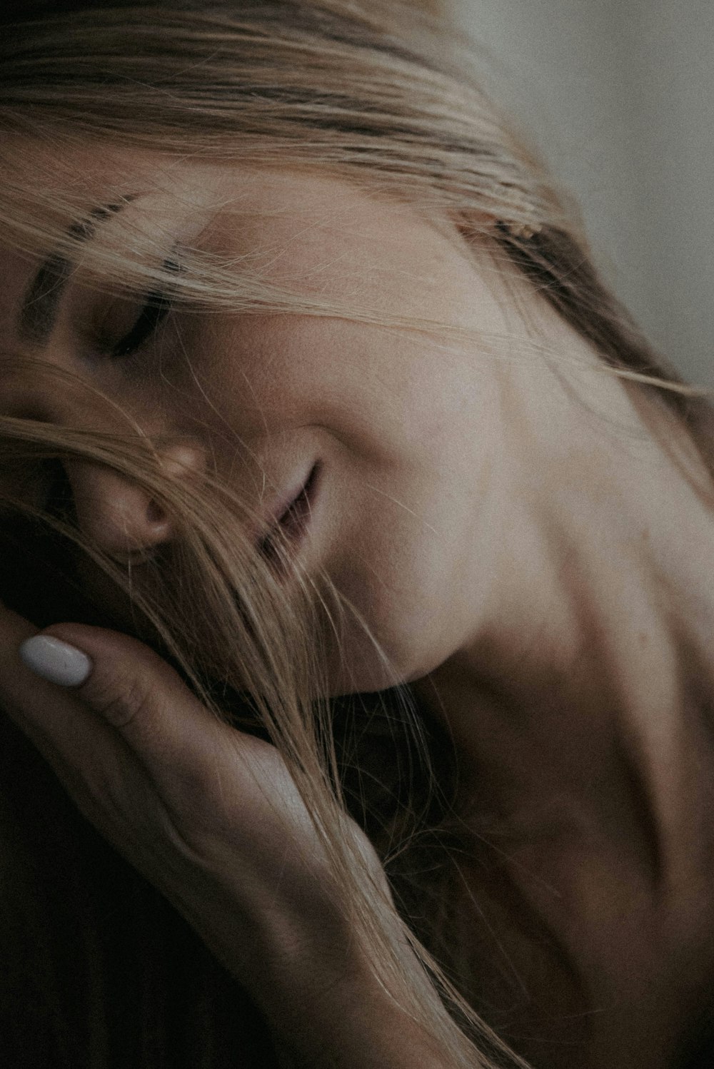 a close up of a woman with her hair blowing in the wind