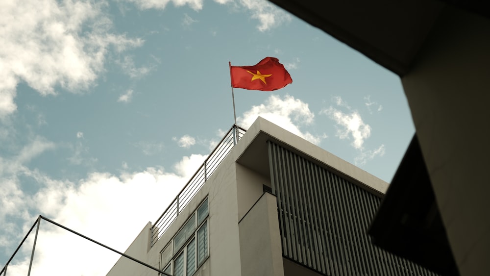 a chinese flag flying on top of a building