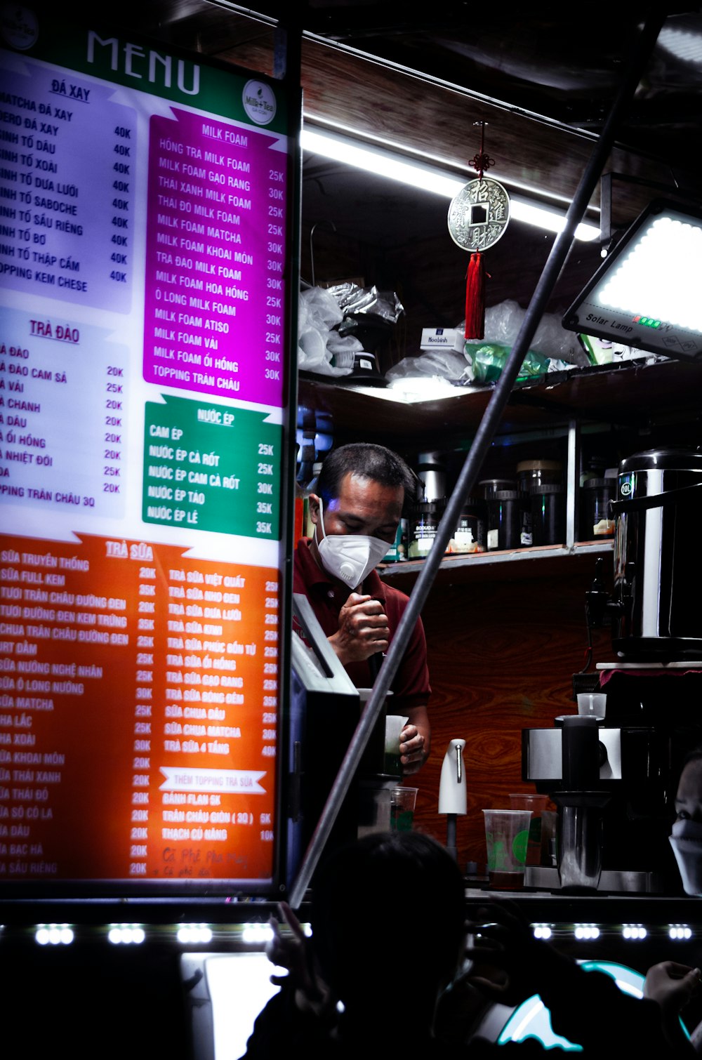 a man standing in front of a menu in a restaurant