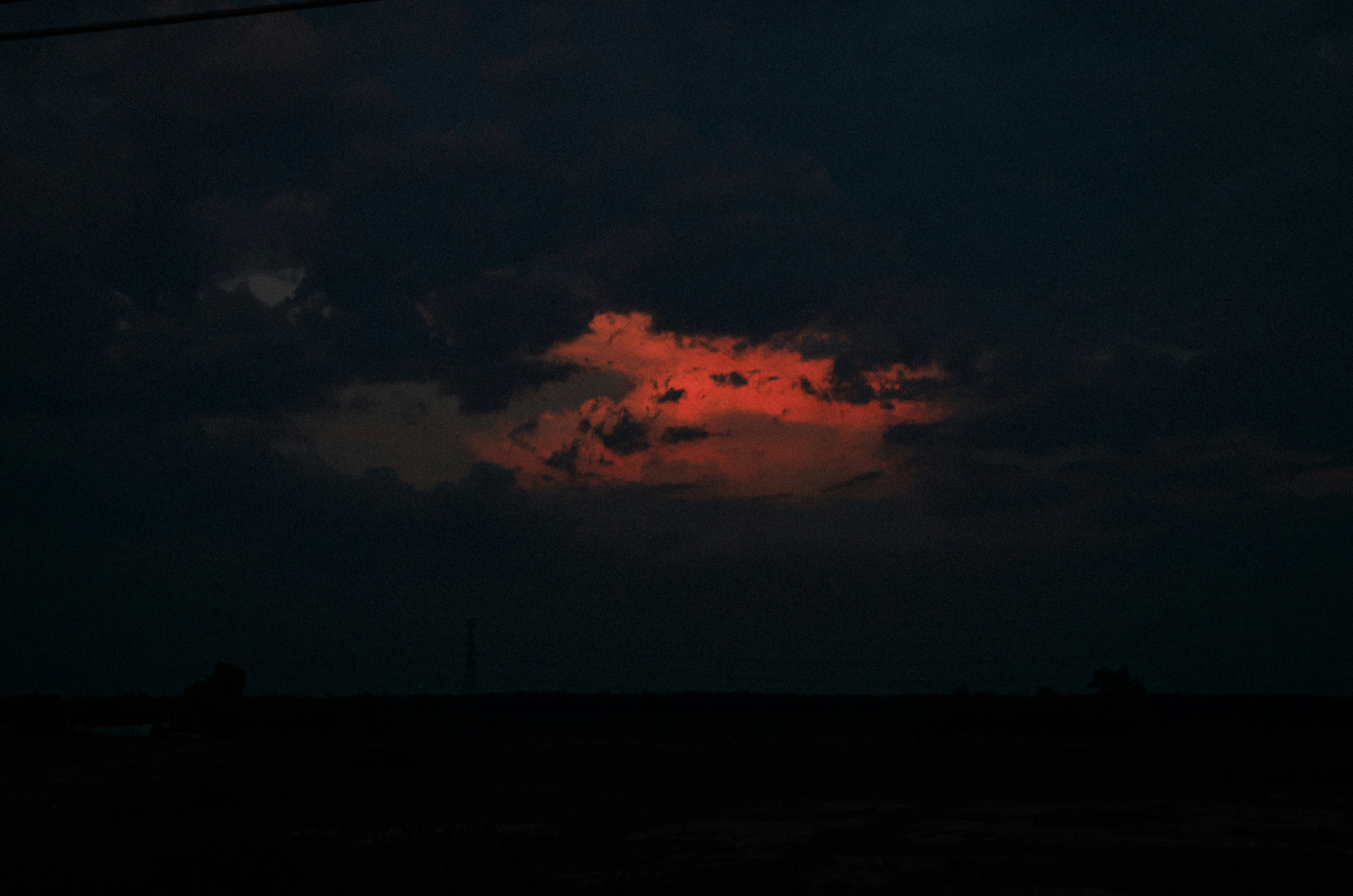 A red cloud is seen in the dark sky photo Free Bình dương Image on