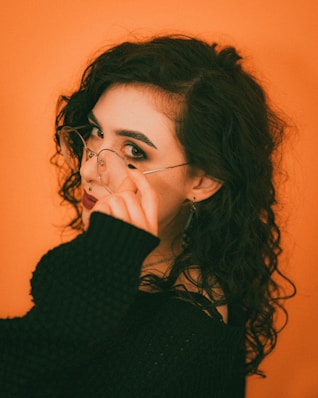 a woman with glasses is posing for a picture