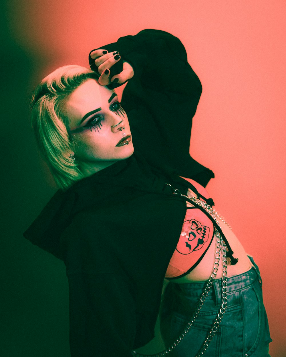 a woman in a black hoodie with tattoos on her back