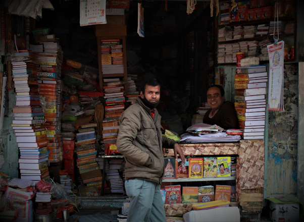 A student happily handing over textbooks to a friendly bookstore clerk at a cozy counter.